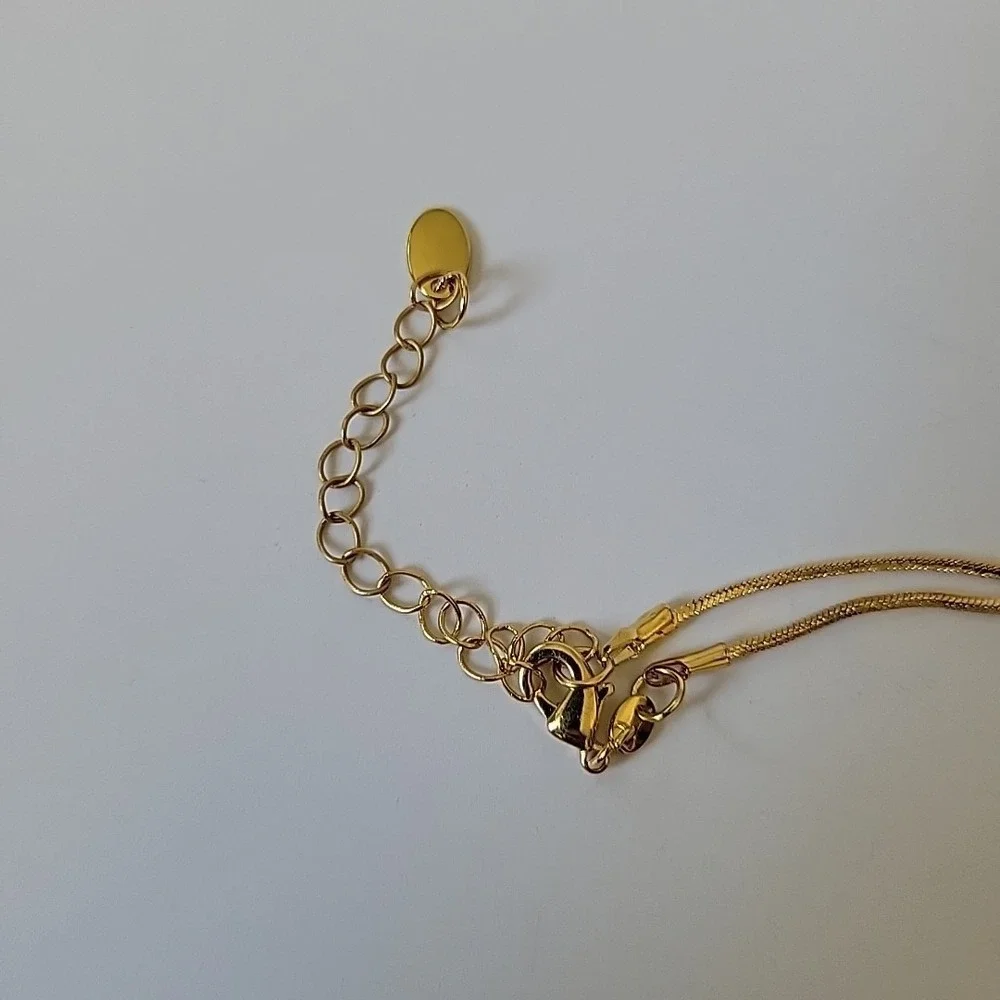 Neckglasses features gold